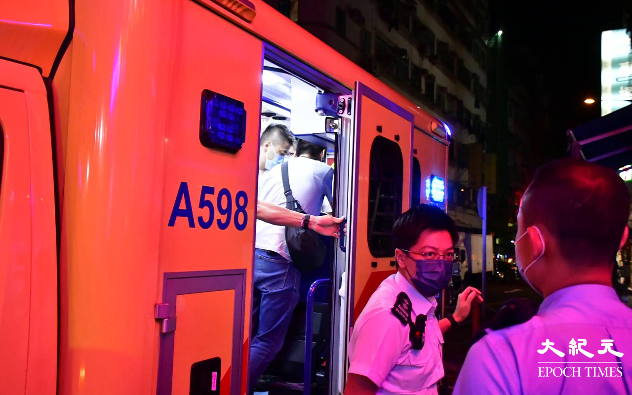 救護員到場後，遇劫受傷事主自行登上救護車，在場警員於救護車上為事主錄取初步口供。（麥碧／大紀元）
