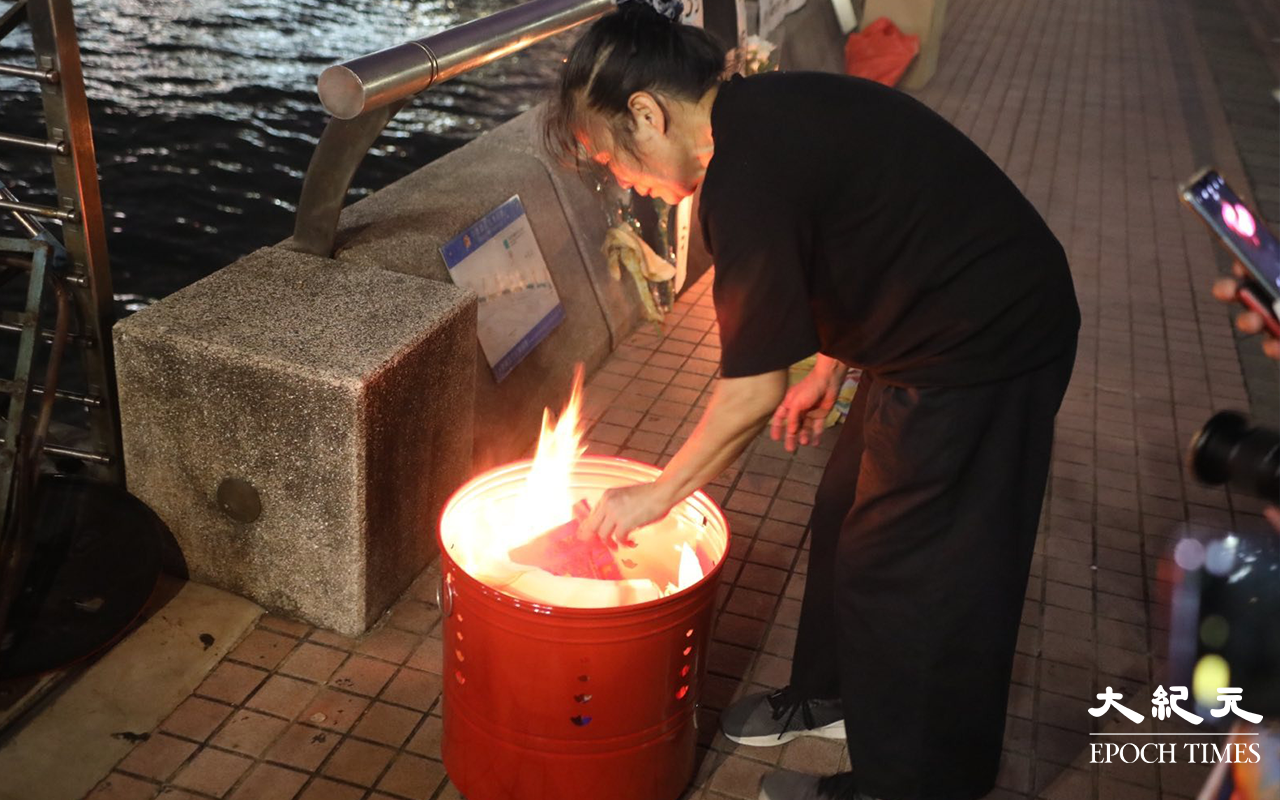人稱女長毛的蓮姐，焚燒冥鏹及與死難者家屬為死難者默哀。（Yan／大紀元）