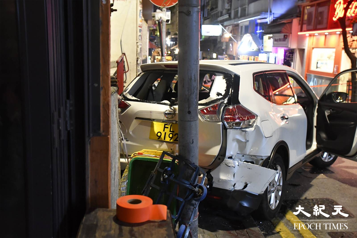 涉案懷疑手掣失靈的白色7人車，撞到士丹頓街41號對開一個石壆後，車尾位置嚴重損毀，車尾玻璃亦已碎裂。（麥碧／大紀元）