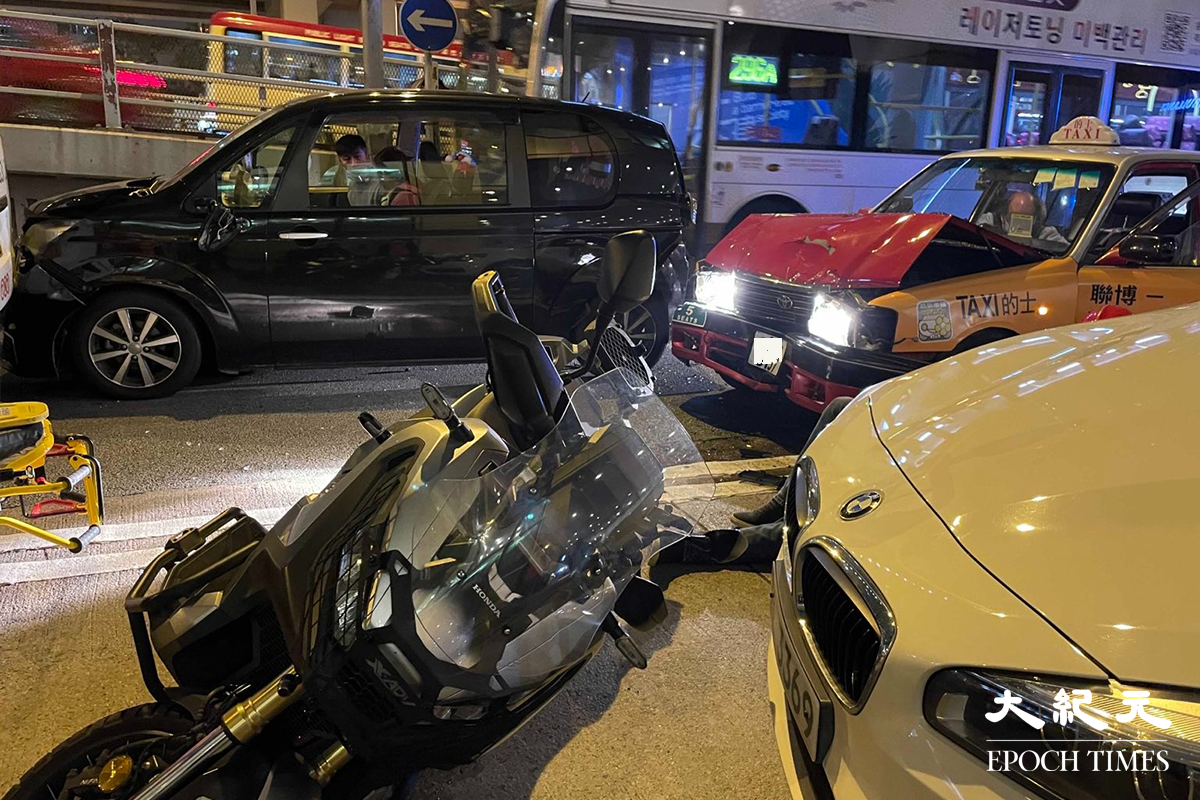意外中，被涉事的士左邊車頭撞到的電單車。（卓相如／大紀元）