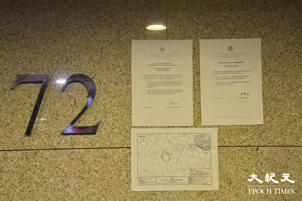 晚上7時，政府刊登憲報後，工作人員隨即在百老匯街72及74號兩棟大廈外牆貼上告示。（麥碧／大紀元）