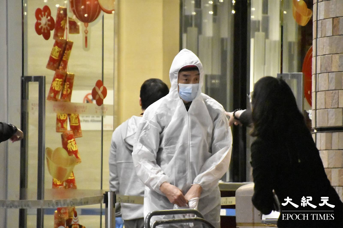 晚上8時10分，東涌藍天海岸現場有工作人員，已更換上全套白色保護裝備。（麥碧／大紀元）