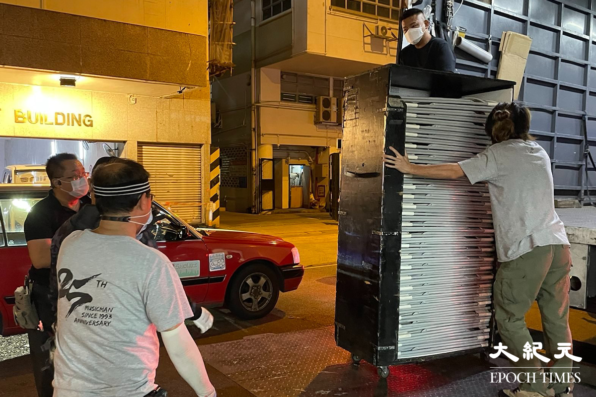 晚上7時35分，大批工作人員運送物資道隆基大樓D座大廈外。（卓相如／大紀元）