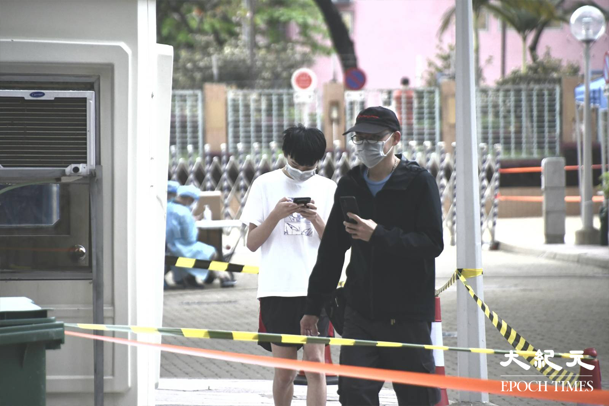 天水圍天盛苑盛泉閣住戶完成強制檢測後，沿指定通道前往物資站領取物資。（麥碧／大紀元）