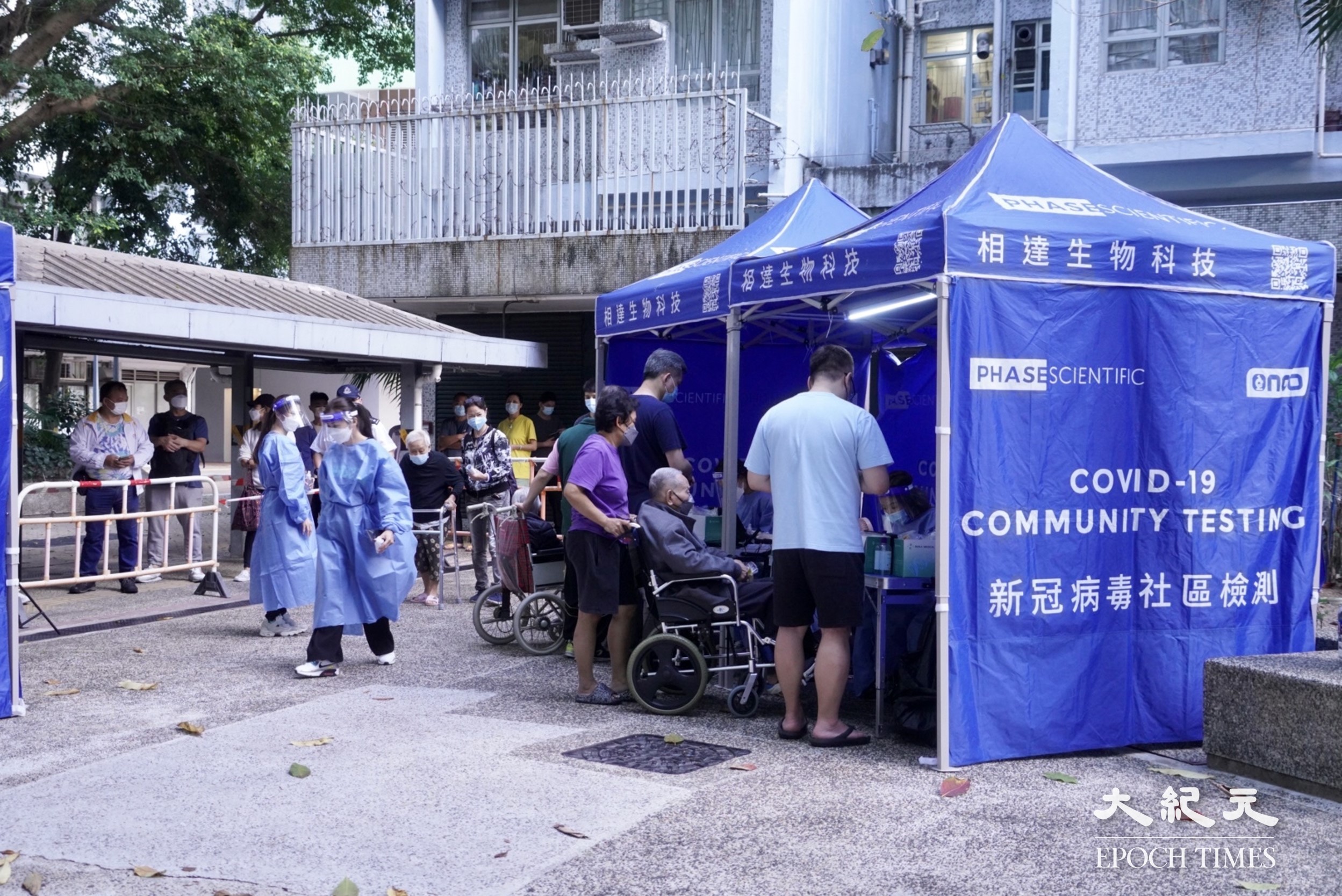 因驗到污水呈陽性，深水埗白田邨澤田樓圍封強檢，住戶收到通知下樓做核酸檢測，有行動不便老人需由親人陪同。（余鋼／大紀元）